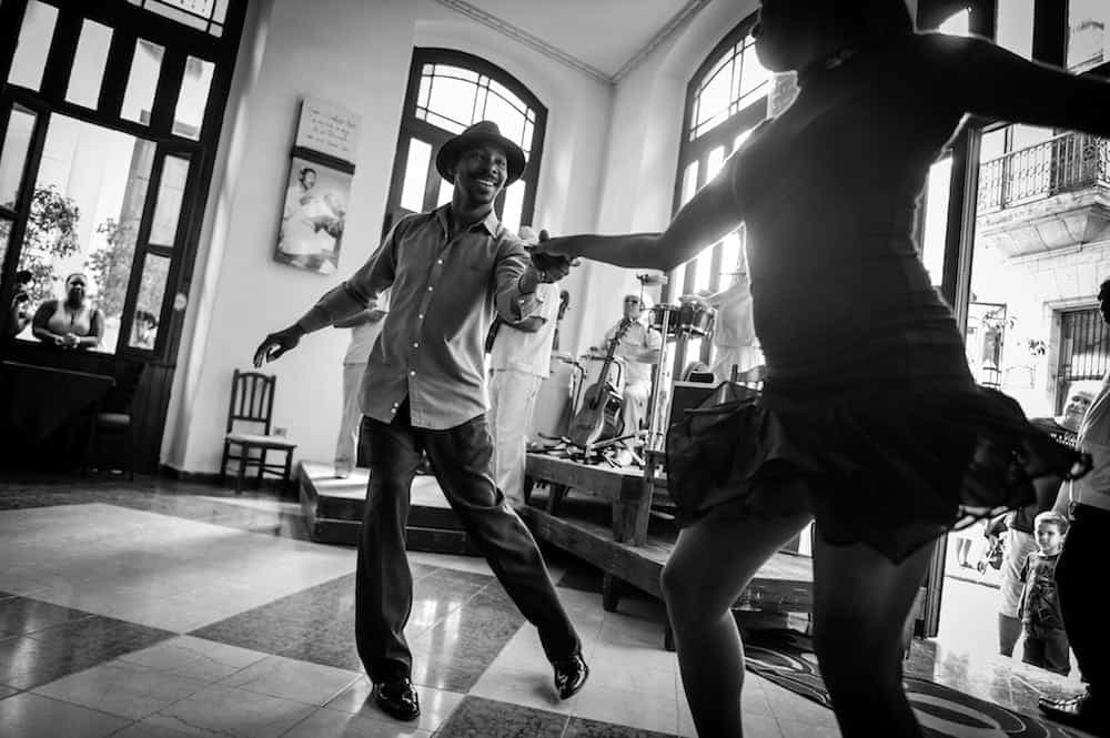 Vibrant salsa dancers performing at Salsa Dallas salsa lessons event in a lively indoor setting.