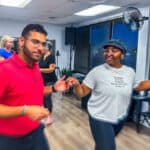 Vibrant salsa dance class at Salsa Dallas studio with students practicing partner moves, showcasing a lively and fun atmosphere for salsa dancing lessons in Dallas.