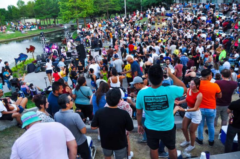 Crowd enjoying outdoor salsa dance event at Dallas park, live music, and dance lessons, vibrant social gathering for salsa enthusiasts in Dallas, Texas.